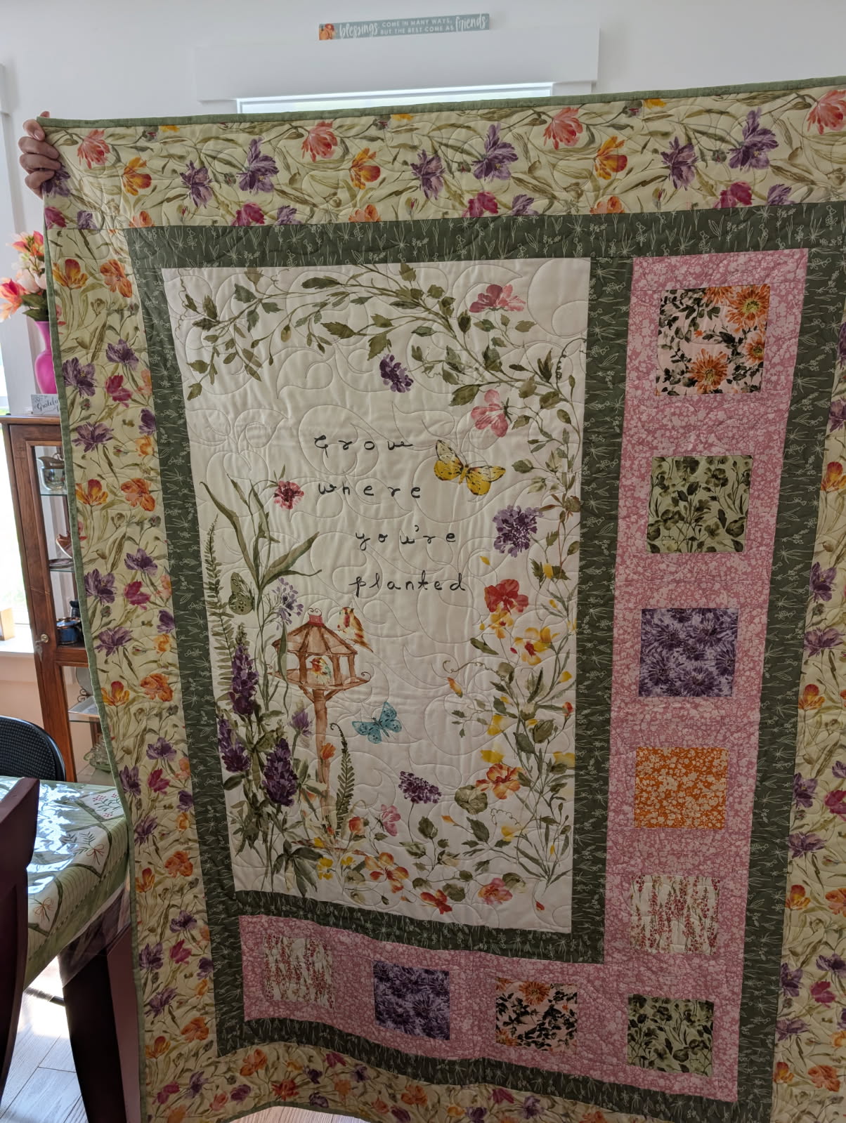 Floral panel quilt with the words Grow Where You're Planted and a birdhouse motif