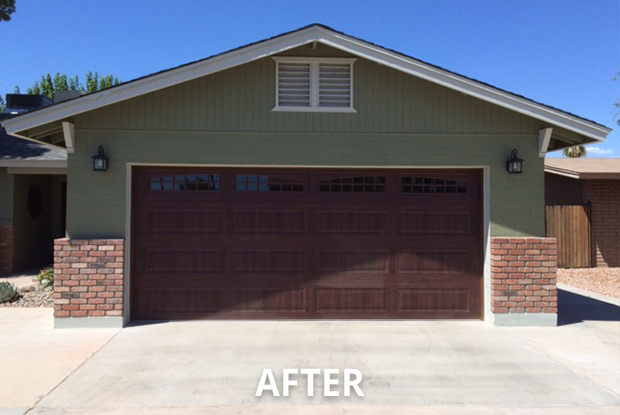 Completed two-car garage conversion with matching brick wainscoting and rich wood-grain door