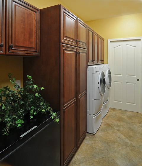 Custom cabinetry extending into pantry and laundry room off the garage