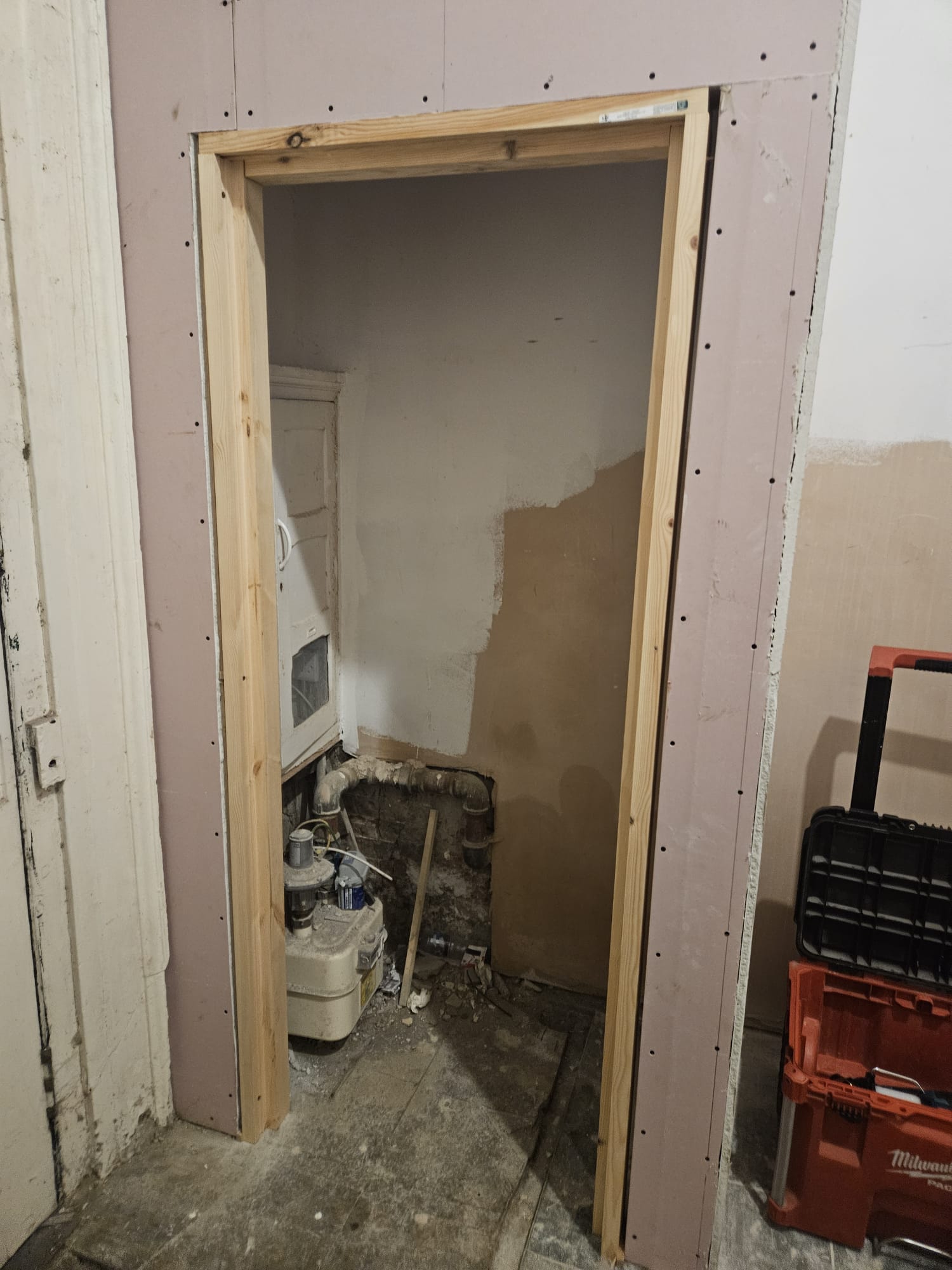 Timber frame construction for fire door opening with plasterboard lining and service integration