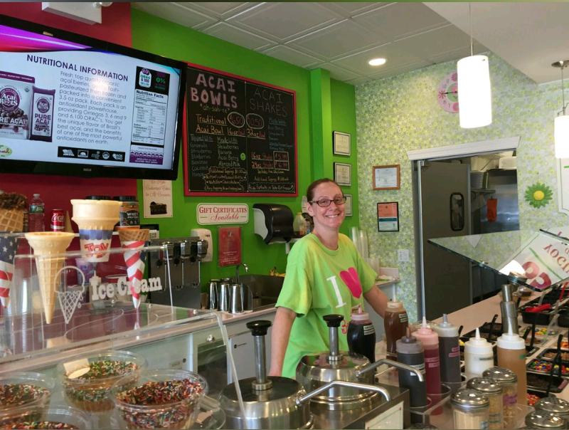 Joanne Jennings, owner of Berry Fresh, smiling behind the counter in her Bayport shop