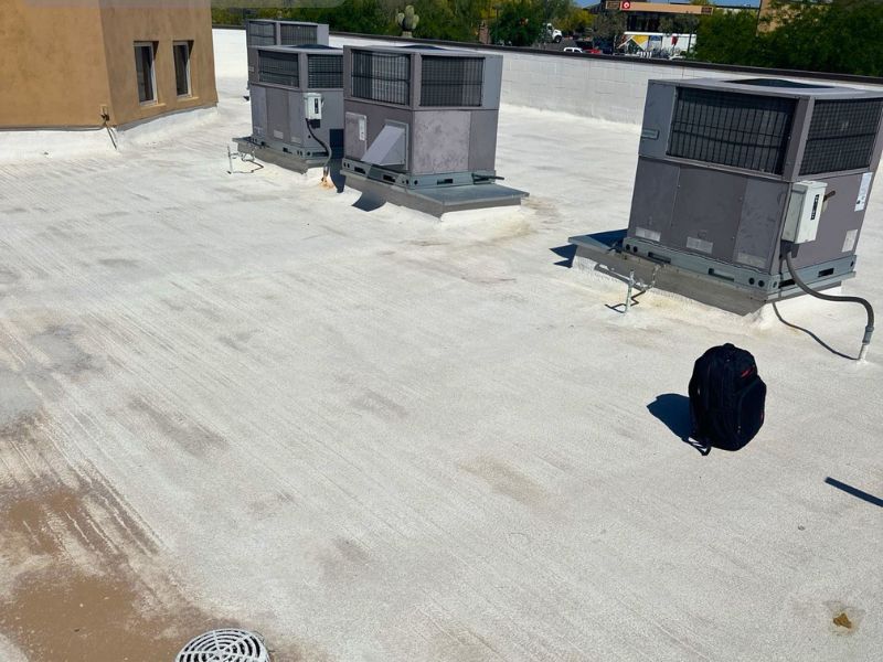 Commercial flat roof inspection in the Phoenix metro area showing membrane evaluation prior to silicone coating