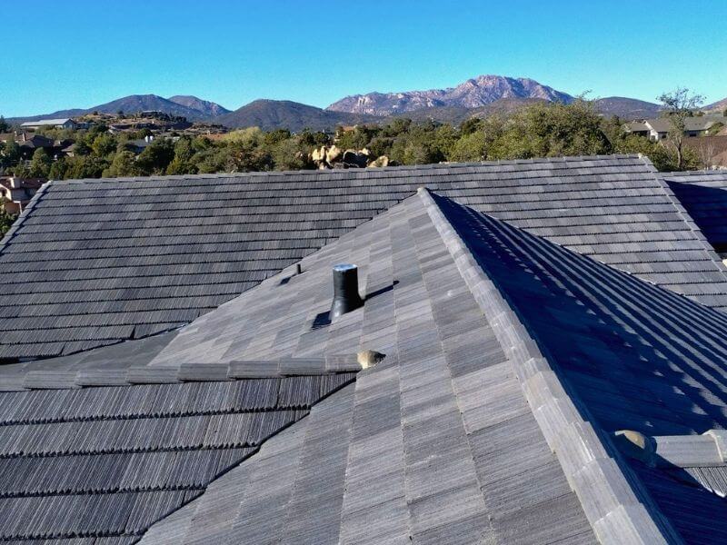 Completed concrete tile roof replacement in Arizona with mountain views