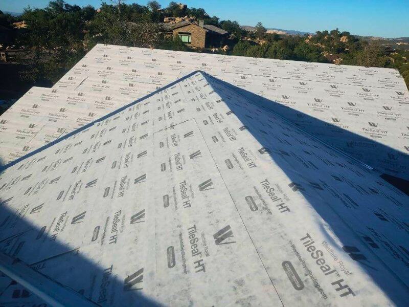 Tile roof inspection in Prescott Arizona exposing aging underlayment and localized moisture concerns
