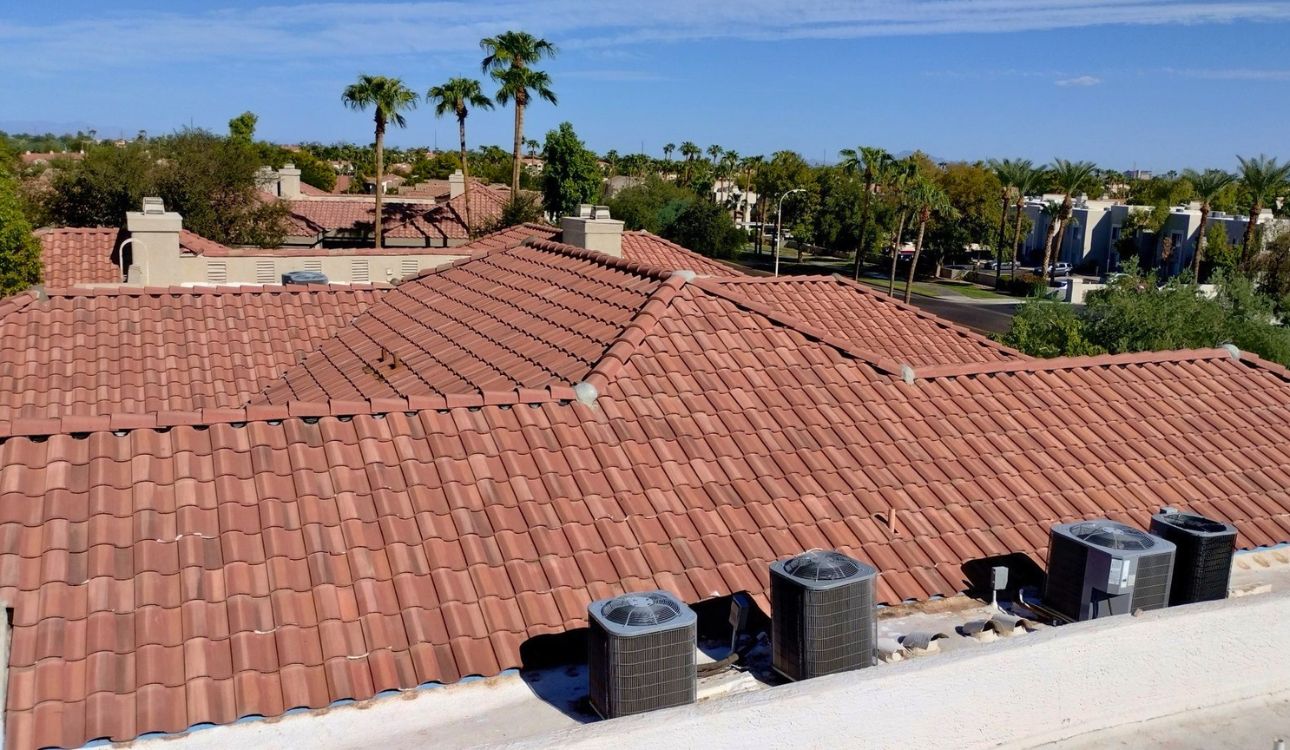 Terracotta concrete tile roof replacement on Chandler Arizona apartment complex with palm trees