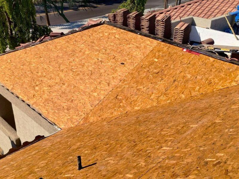 New OSB roof decking installed on Chandler Arizona apartment complex during tile roof replacement