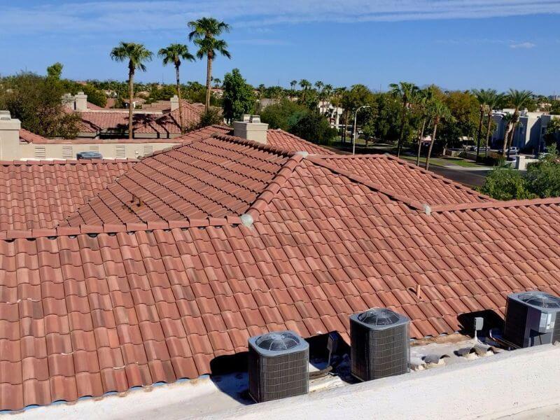 Completed terracotta concrete tile roof replacement on a Phoenix metro area property with palm trees