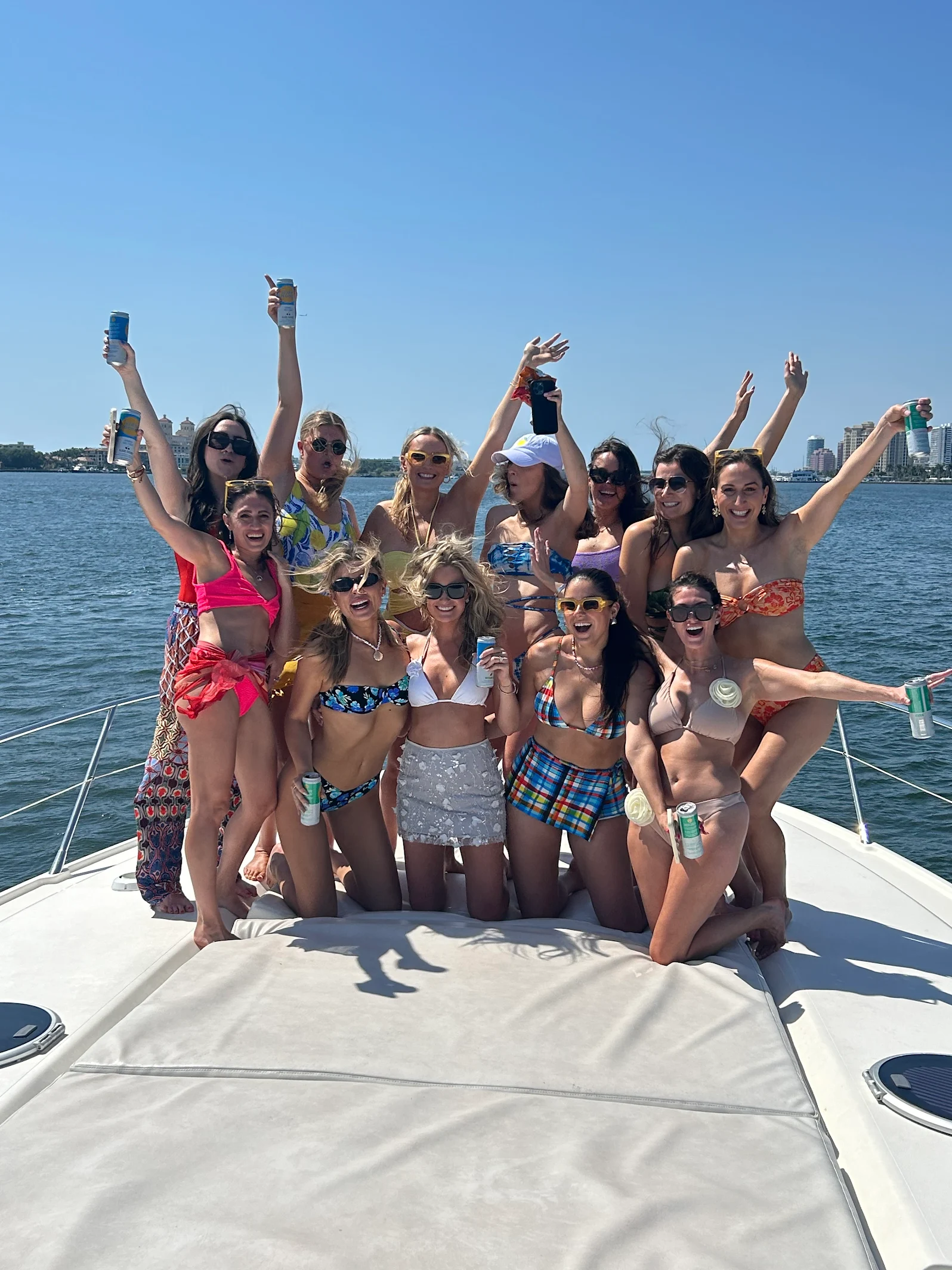 Bachelorette yacht party Palm Beach with a bridal group celebrating with drinks on the bow