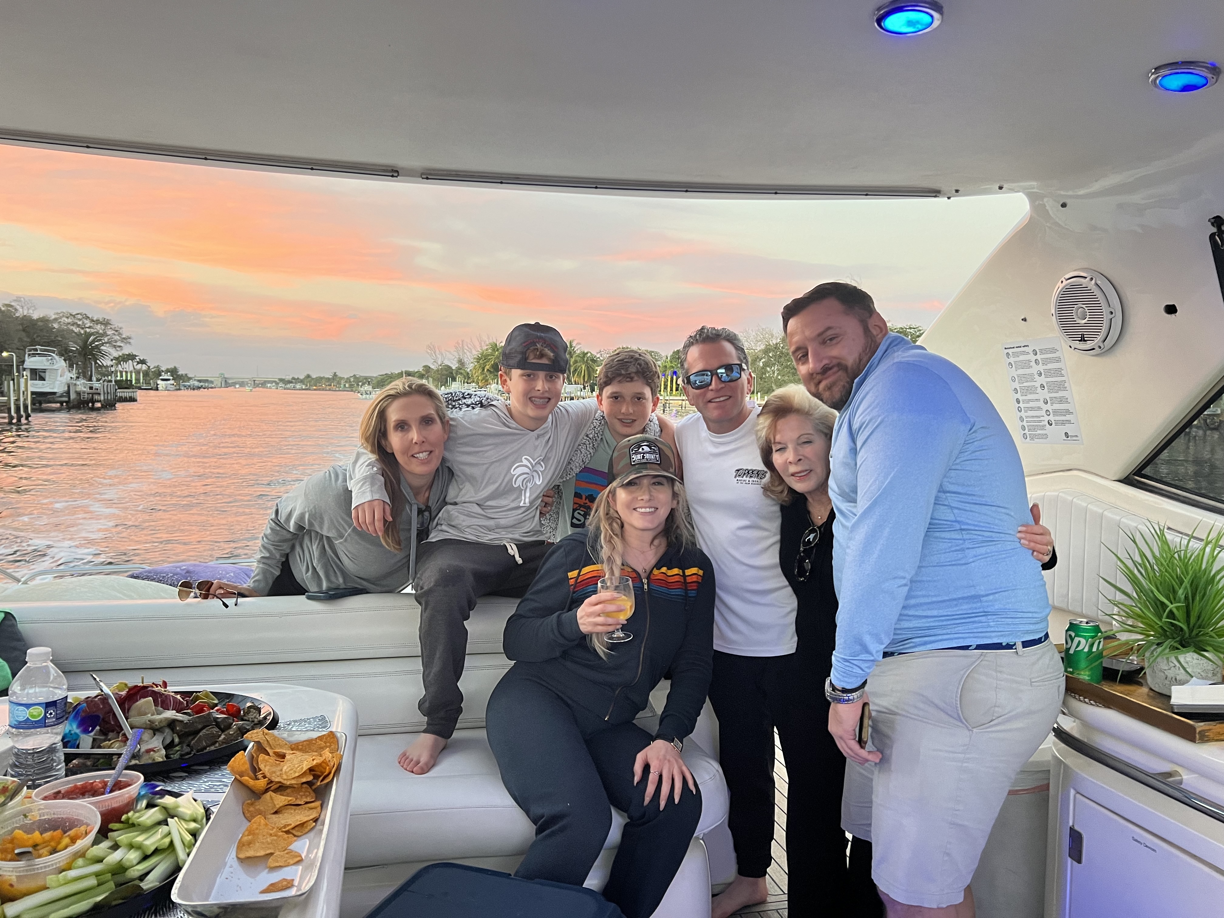 Sunset cruise Palm Beach with family and friends enjoying cocktails and appetizers aboard yacht