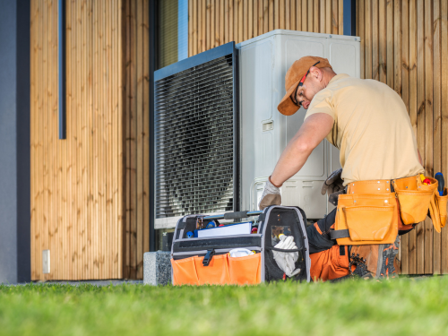 Master Technician Paul Walsh inspecting home heating system