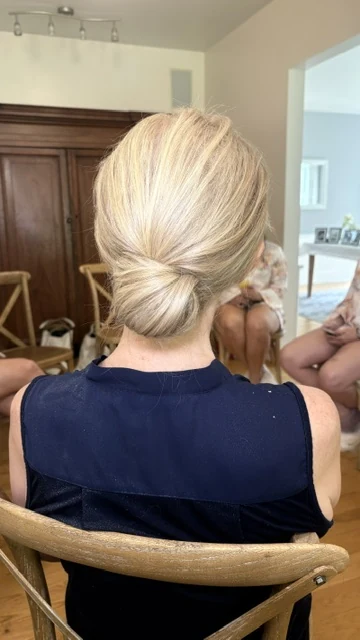 Polished chignon up-style for special occasion by Jessica Young — blonde hair swept into elegant low bun, full head visible