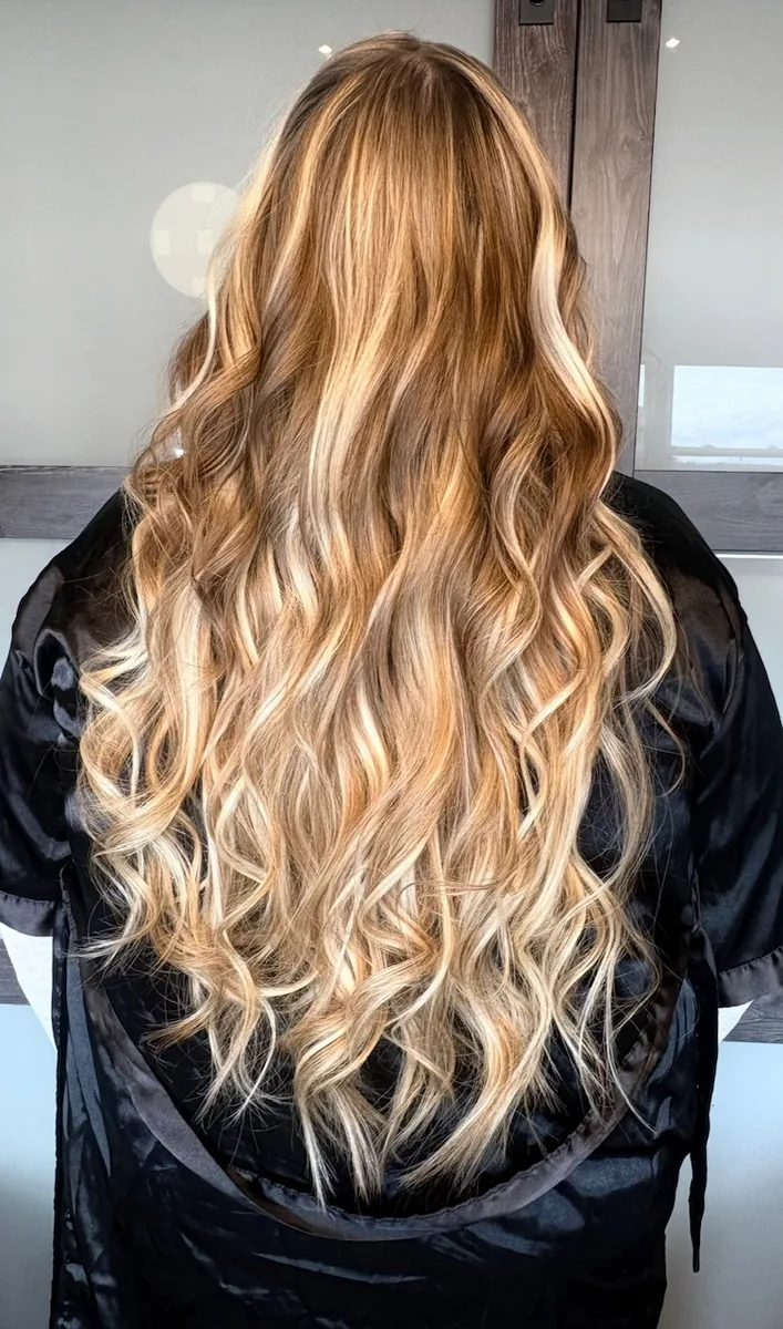 K-Tip hair extensions for length and volume by Jessica Young — long honey-toned balayage with dimensional blonde highlights, full head visible