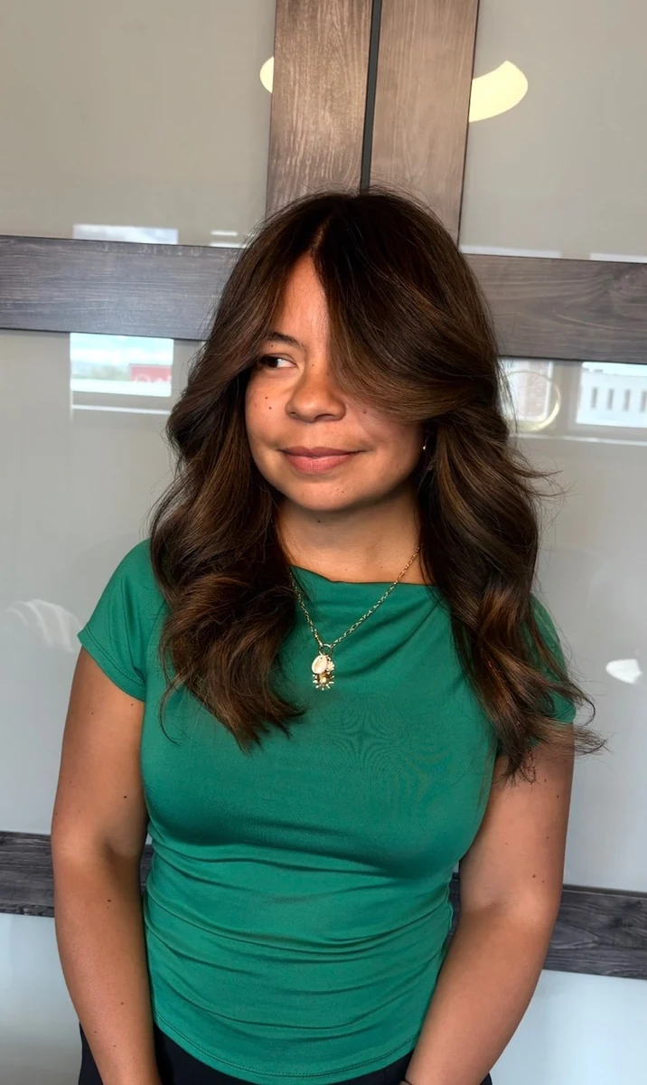 Professional blow-out and style by Jessica Young — dimensional caramel balayage with face-framing layers and soft wave, full head visible