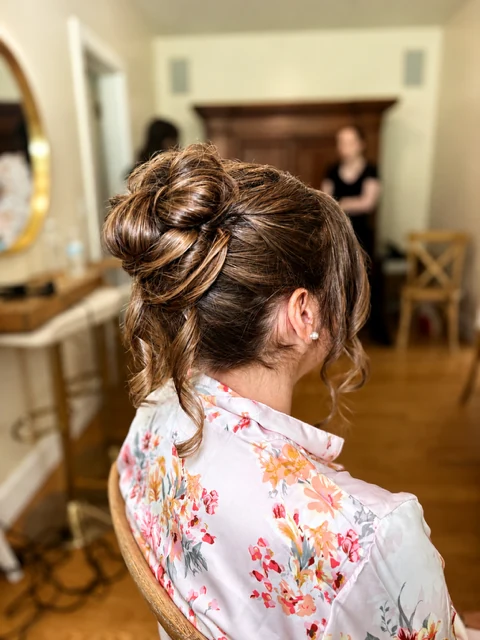 Textured bridal up-do special occasion hair by Jessica Young — twisted up-style with loose tendrils and warm brunette tones, full head visible