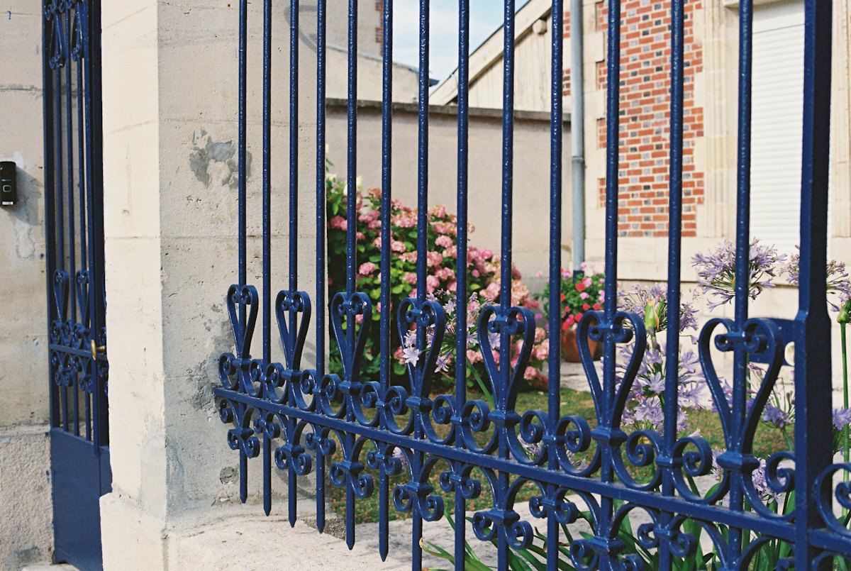 Ornamental wrought iron fence along a property line in Arlington TX