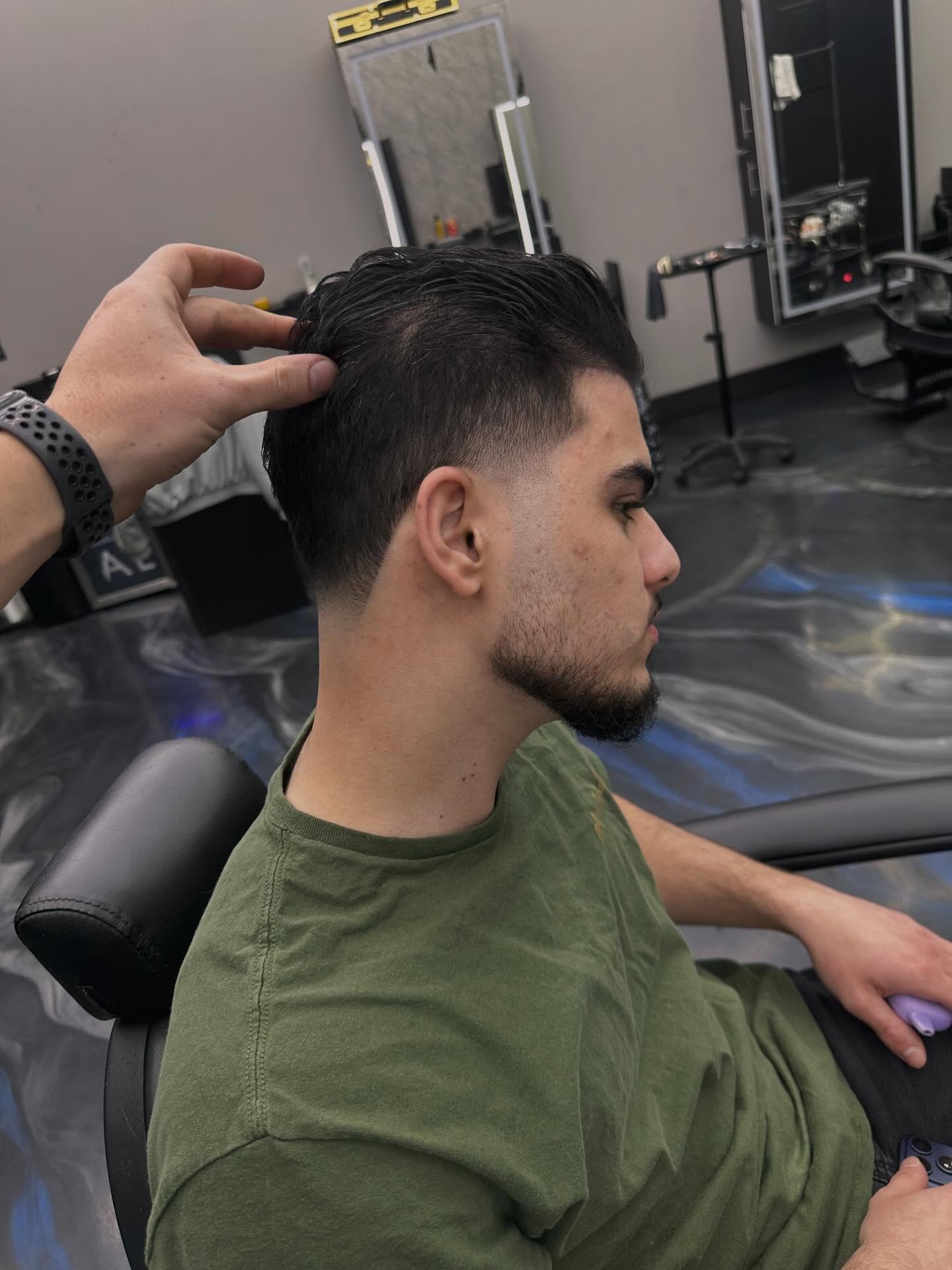 Low taper fade with slick back