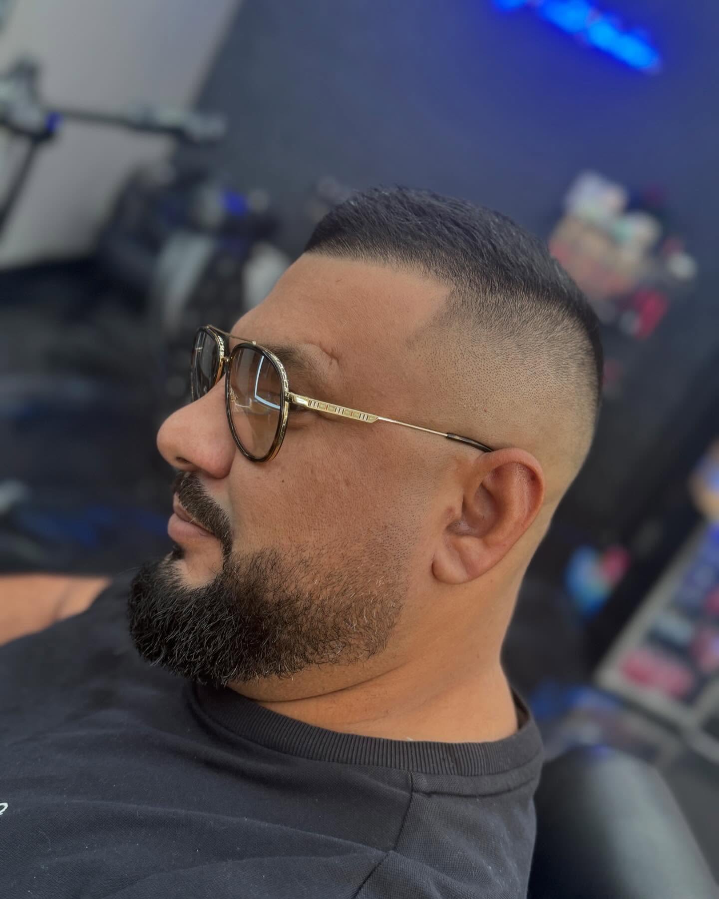 High skin fade with sculpted beard