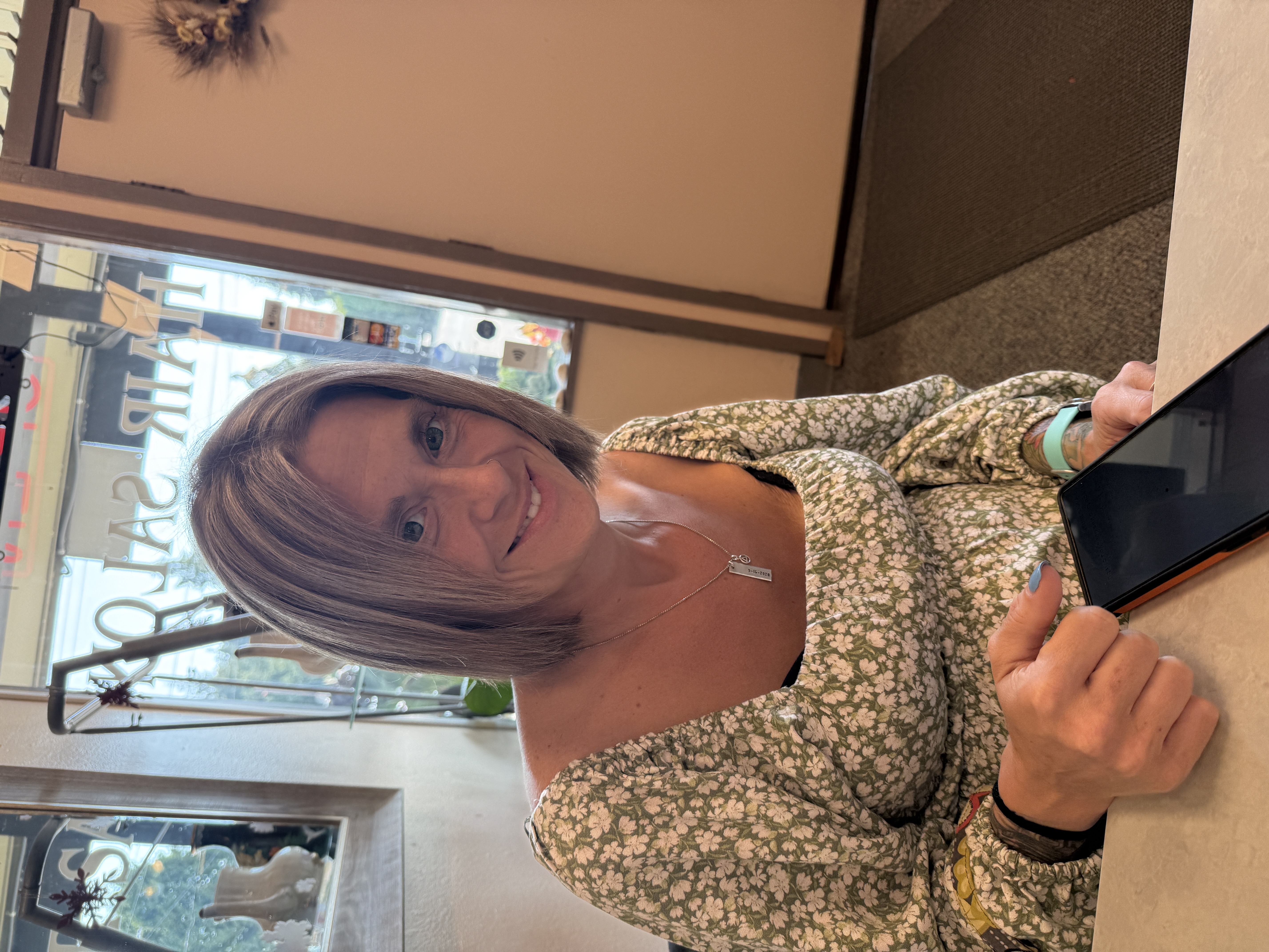 Client with dimensional blonde highlights and a modern textured cut at Ideal Hair Salon in