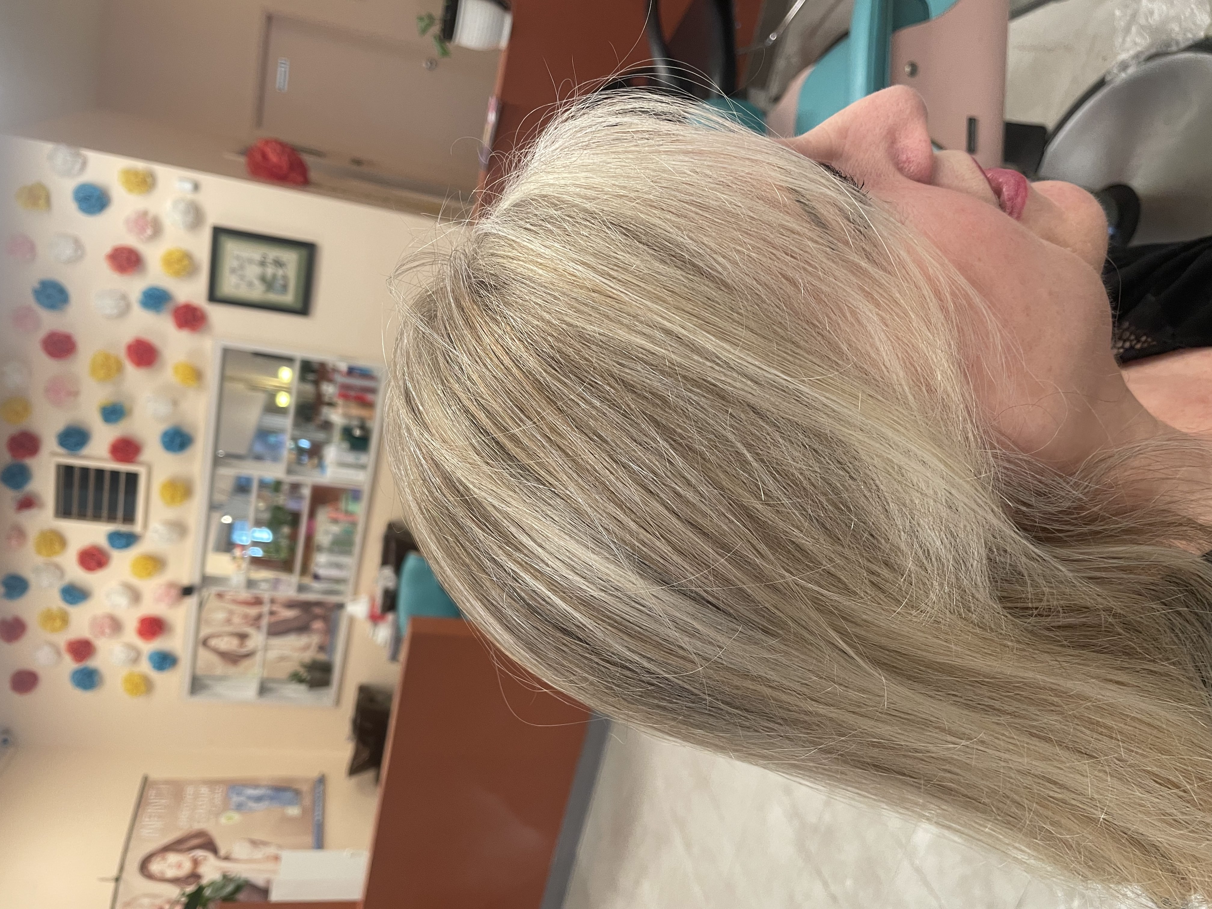 Client hair transformation with dimensional blonde highlights and custom tones in Edmonds, WA salon.