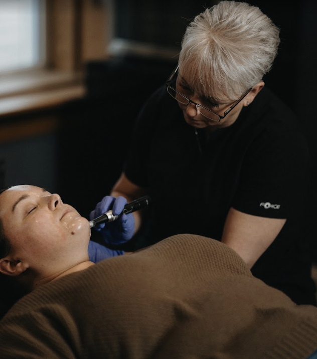 Dawn Monroe treating a client at D'Vinely You Aesthetics med spa