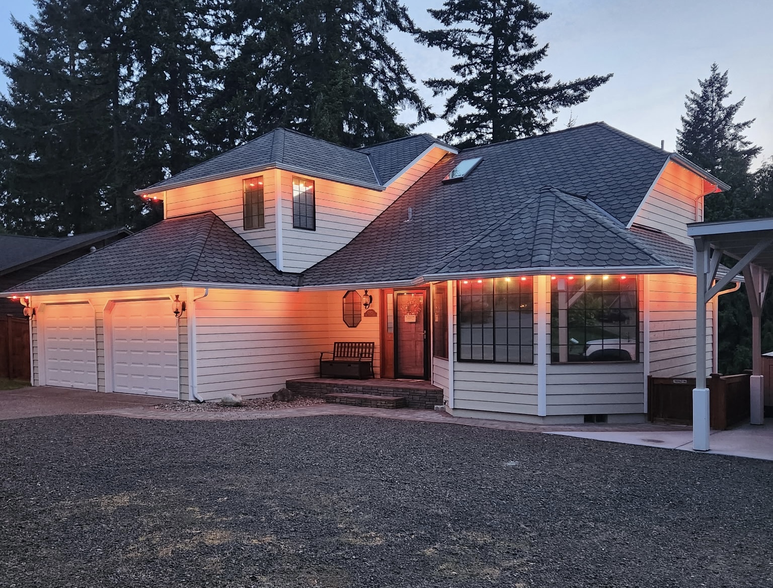 Home with warm architectural roofline lighting