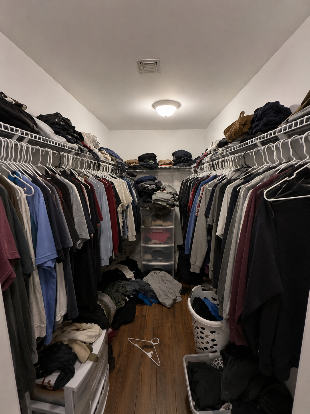 Cluttered closet with wire shelving before custom closet installation