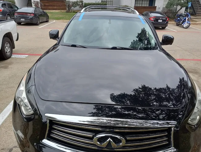Completed mobile windshield replacement on an Infiniti SUV in Dallas, Texas with retention tape during cure time