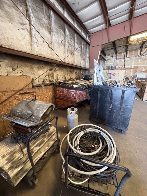 Coiled electrical cables and wire spools on cart with metal sheets at Valdez Recycling facility