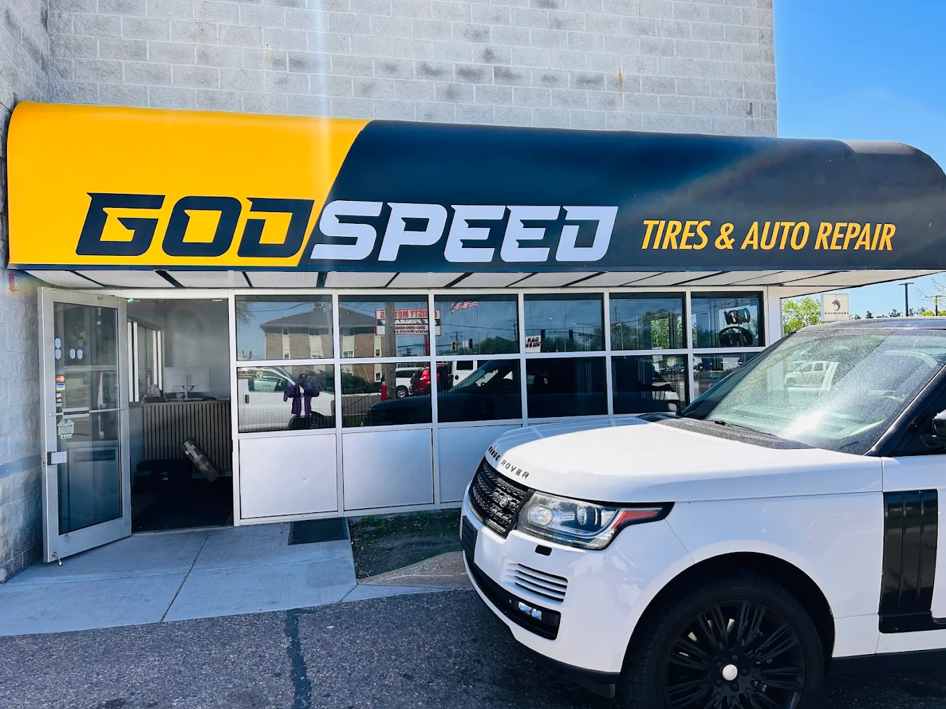 God Speed Tires & Auto Repair storefront building with Range Rover