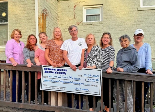 100 Women Who Care Lorain County check presentation to We Care We Share My House program