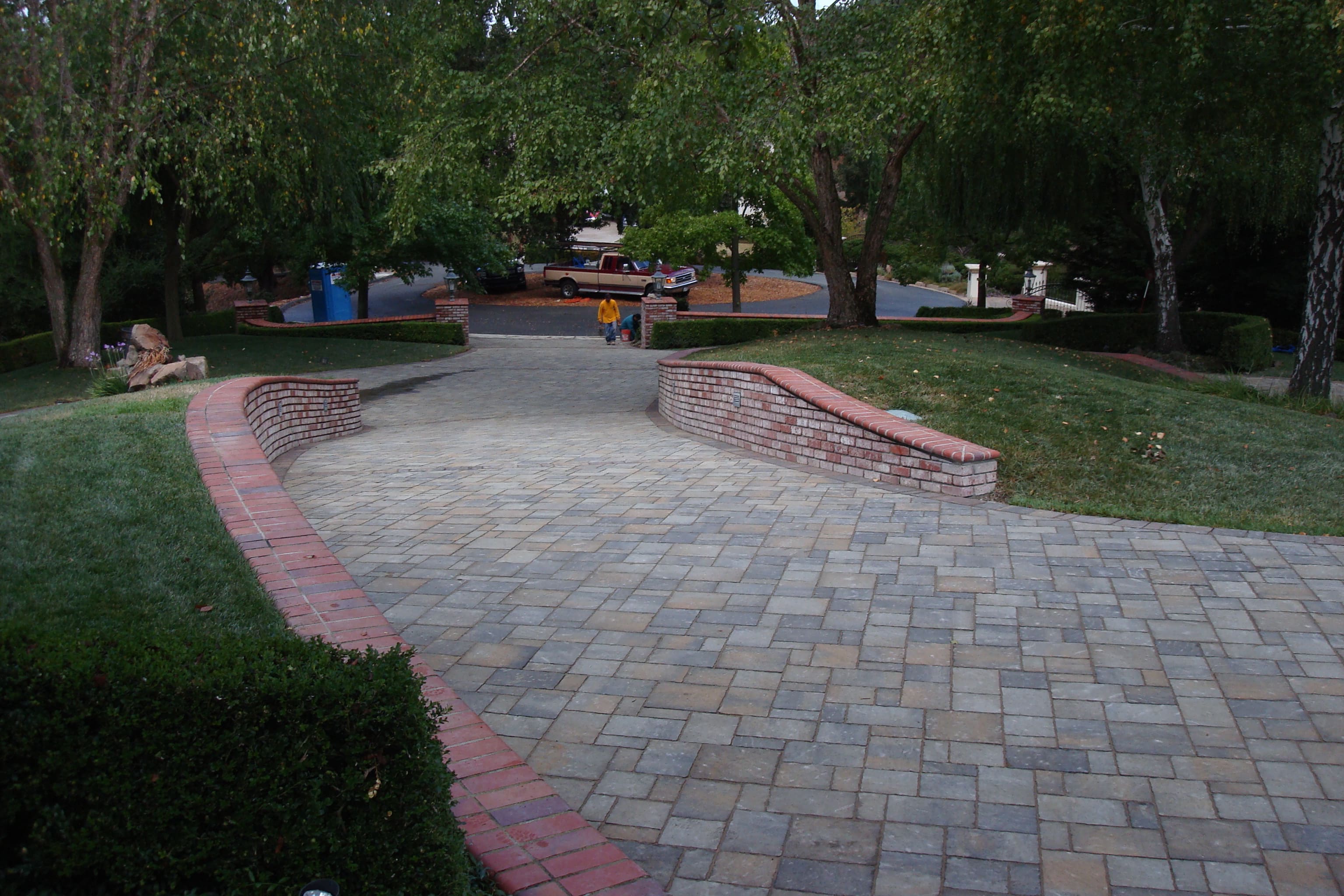Curved paver walkway with brick retaining walls and custom brick caps - masonry materials from Paradise Building Materials