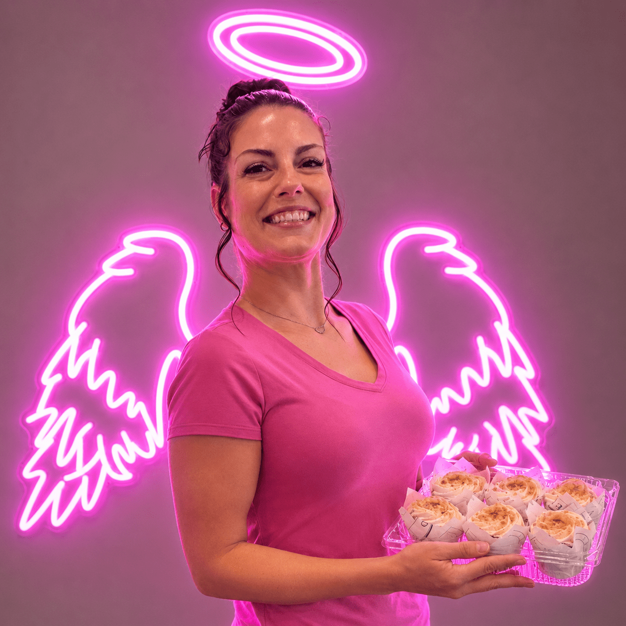 Owner of Sweet Tooth Creations holding a tray of fresh baked cupcakes in Anchorage Alaska