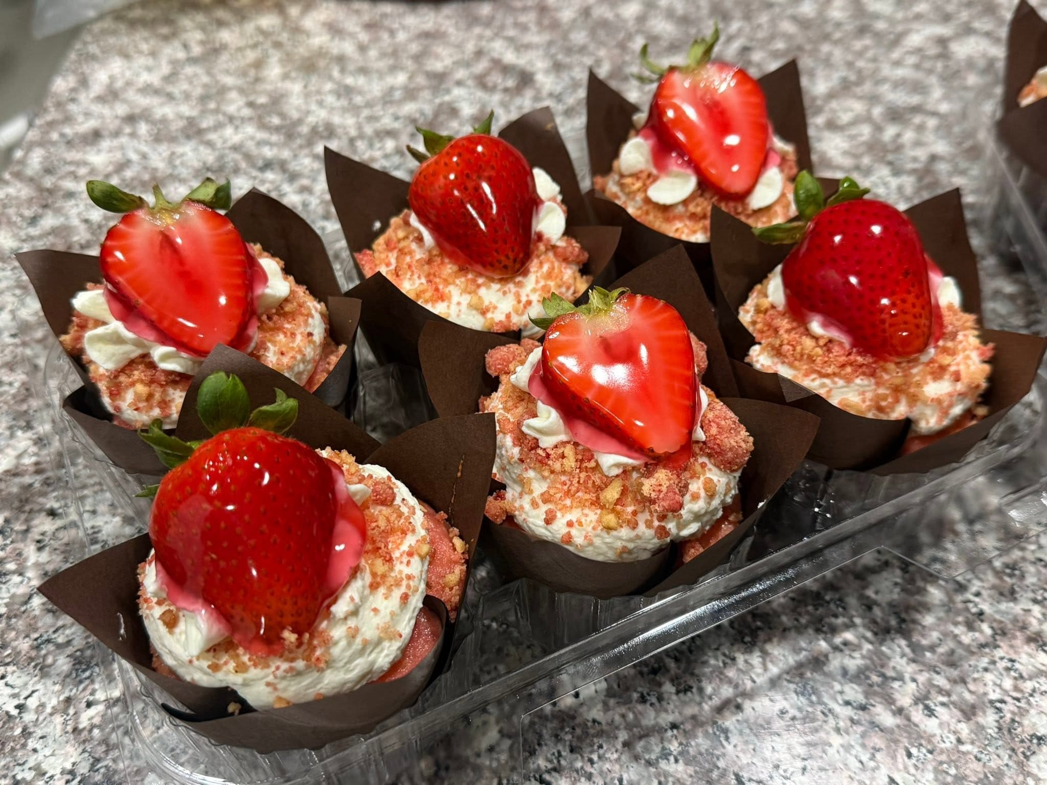 Strawberry shortcake cupcakes with fresh glazed strawberries white frosting and crumb topping from Sweet Tooth Creations Anchorage bakery