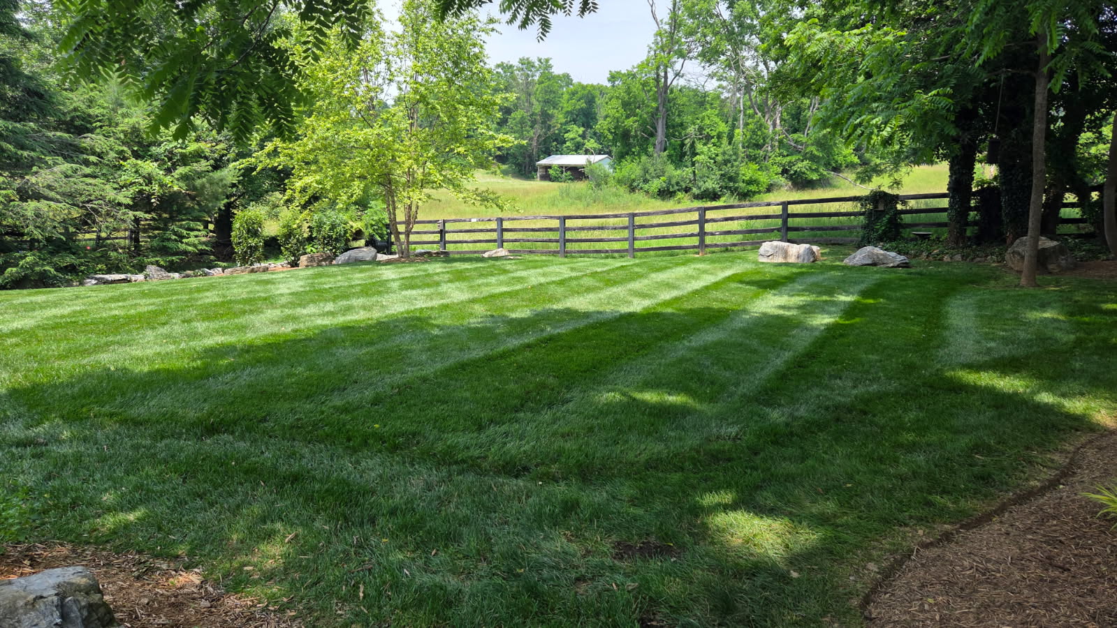 Large Fenced Estate Backyard with Boulders - Lawn Man LLC Winchester VA