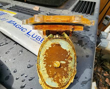 Rusted pool equipment component before repair