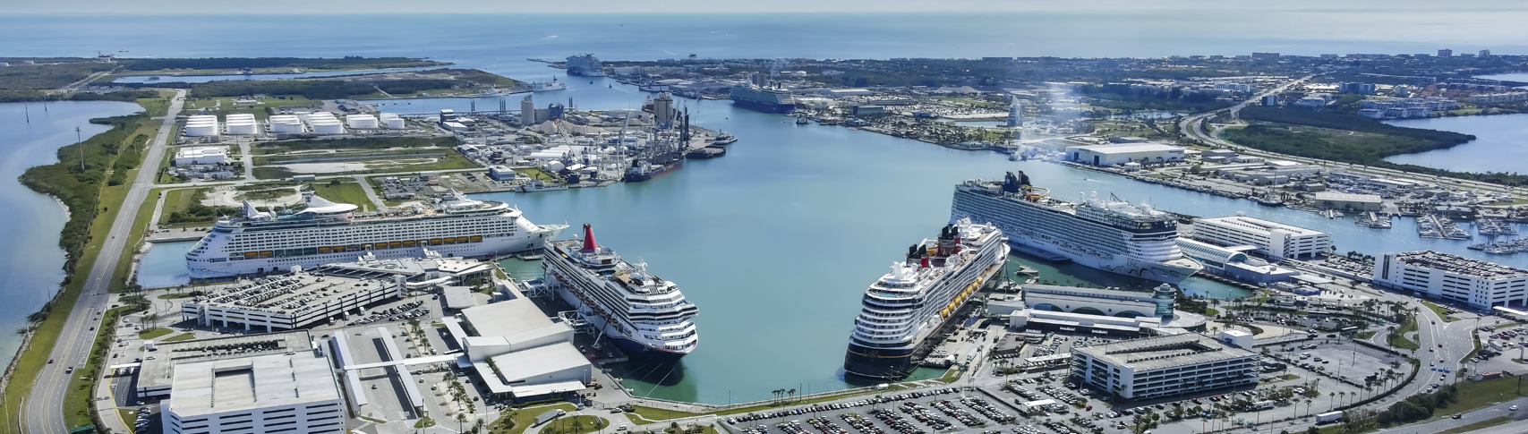 Panoramic aerial view of cruise ships docked at the modern Port Canaveral terminals and harbor basin on Florida's Space Coast