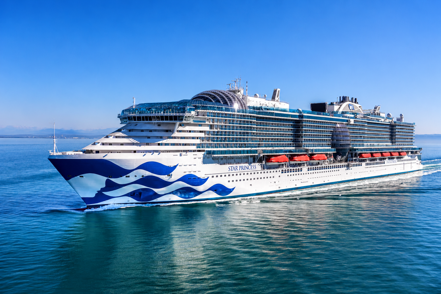 Star Princess cruise ship sailing across vibrant blue ocean waters on a sunny day