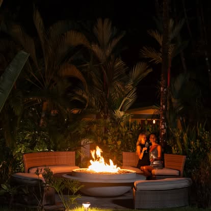 Evening fire pit lounge area at Astra Boutique Hotel