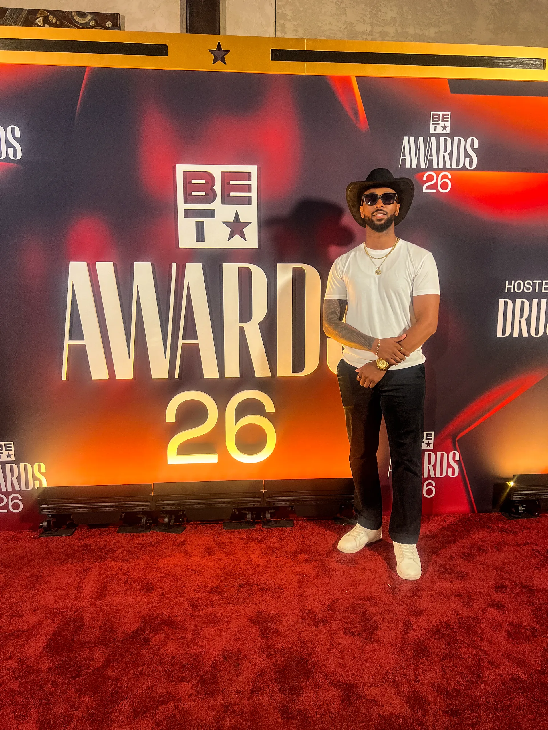 Jai'koa Parham at the BET Awards red carpet in a cowboy hat and sunglasses, red carpet event appearance