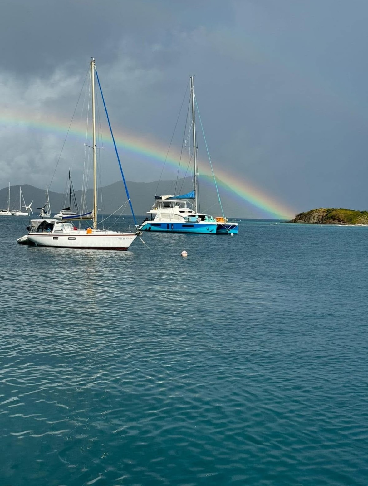 Sailboats anchored in a tranquil Caribbean bay