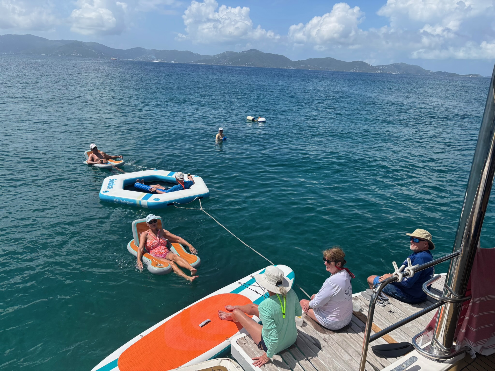 Guests relaxing on deck with water toys in the BVI