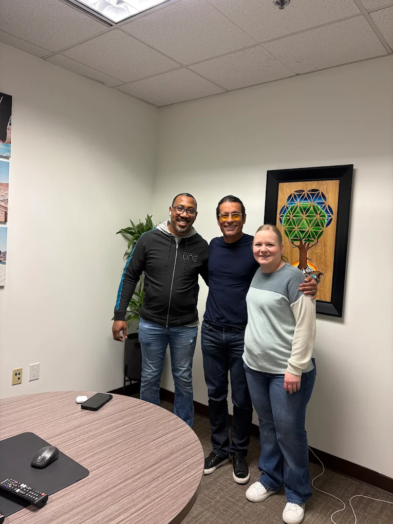 First-time homebuyer family at closing with The Mortgage Phoenix Group.