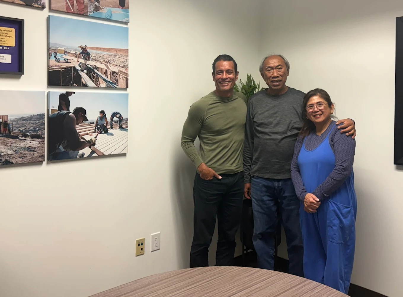 First-time homebuyer family at closing with The Mortgage Phoenix Group.