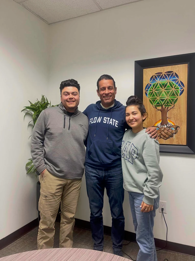 First-time homebuyer family at closing with The Mortgage Phoenix Group.