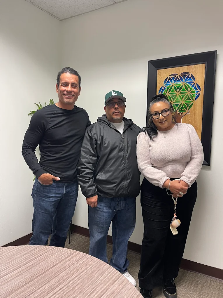 First-time homebuyer family at closing with The Mortgage Phoenix Group.