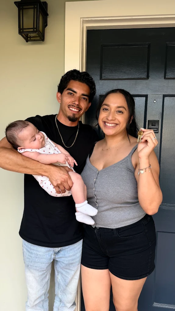 First-time homebuyer family at closing with The Mortgage Phoenix Group.