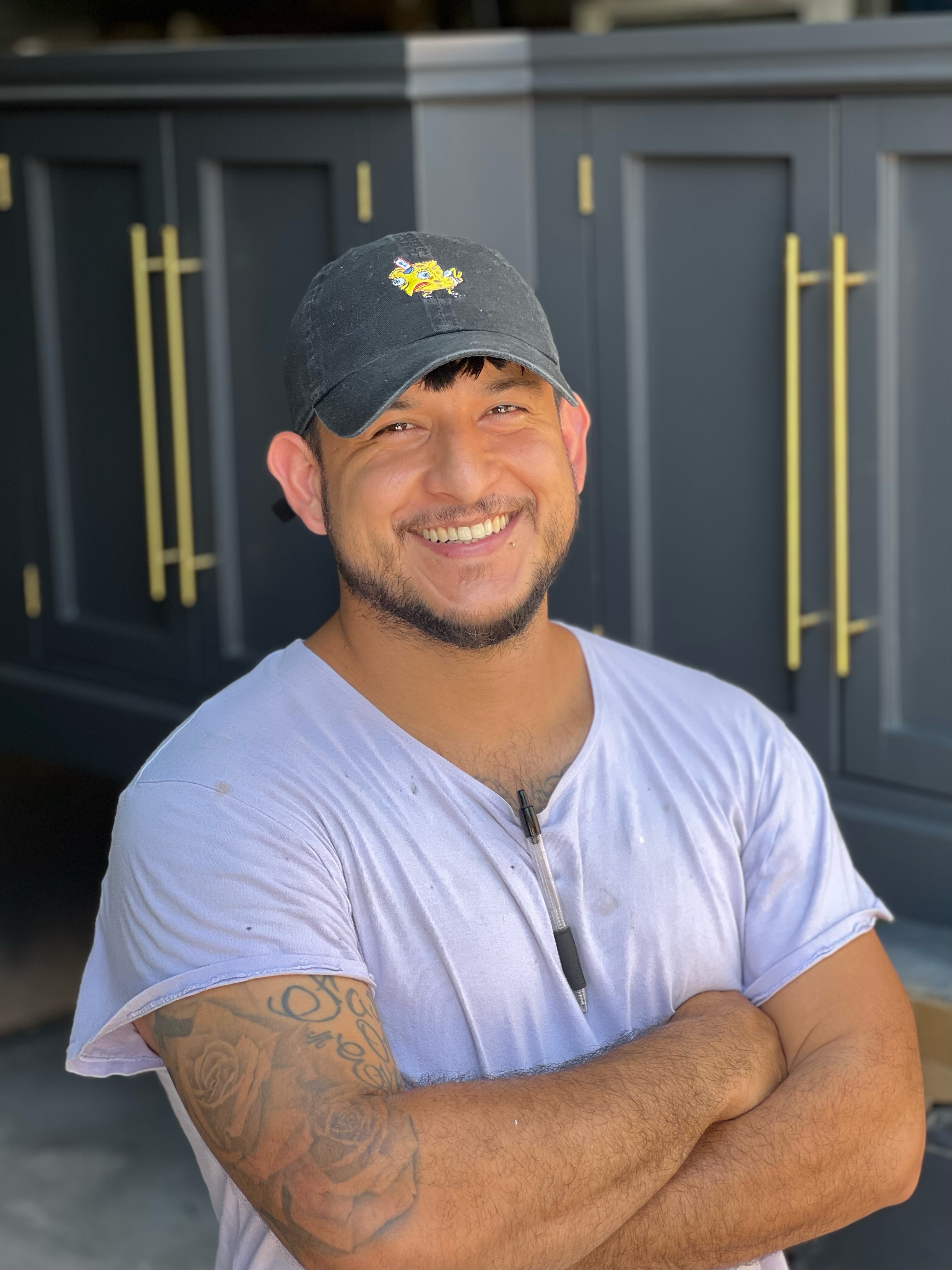 Jesus Garcia, owner of Rose Painting Group, standing in front of freshly painted cabinetry in Houston, TX
