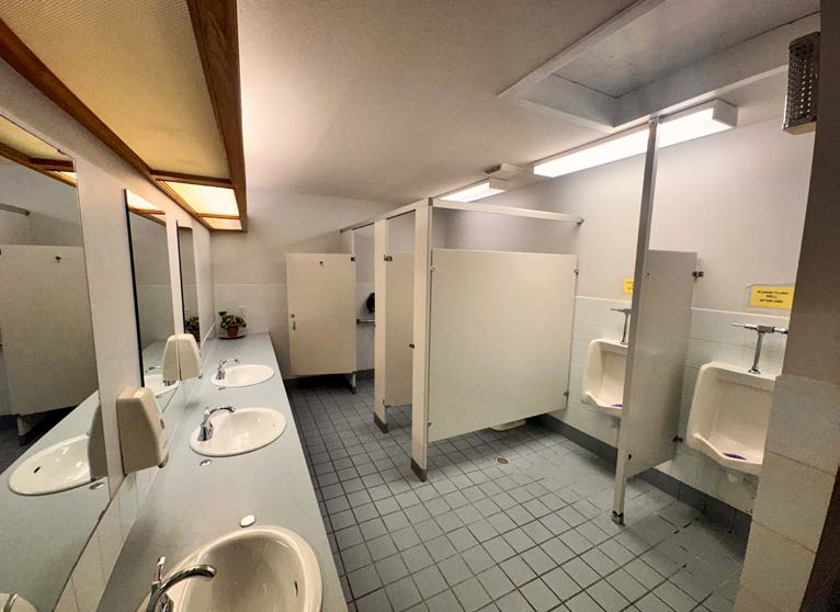 Washroom facilities with sinks and stalls inside the property
