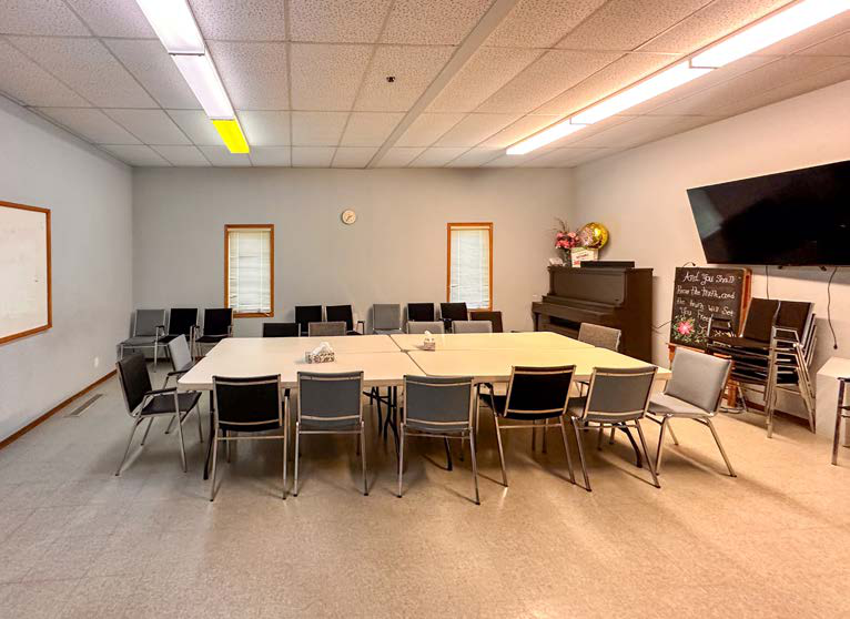 Meeting room with tables and chairs for community gatherings
