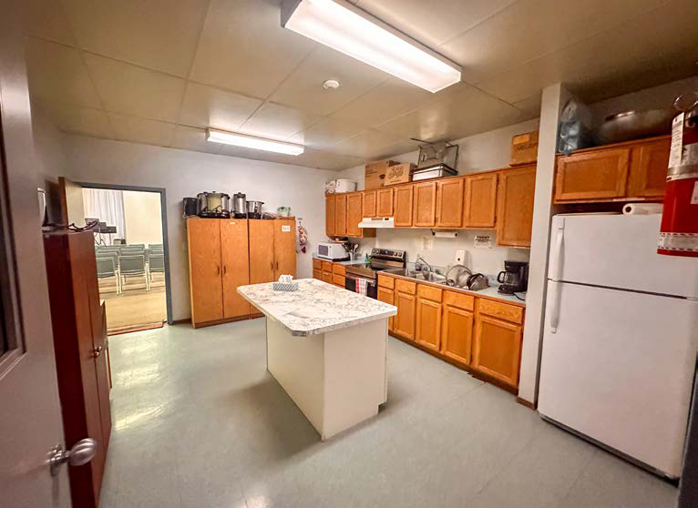 Kitchen area with wooden cabinets and appliances inside the property